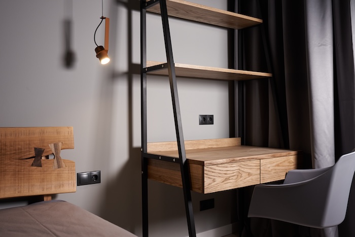 Bedroom corner with wooden wall shelf and desk