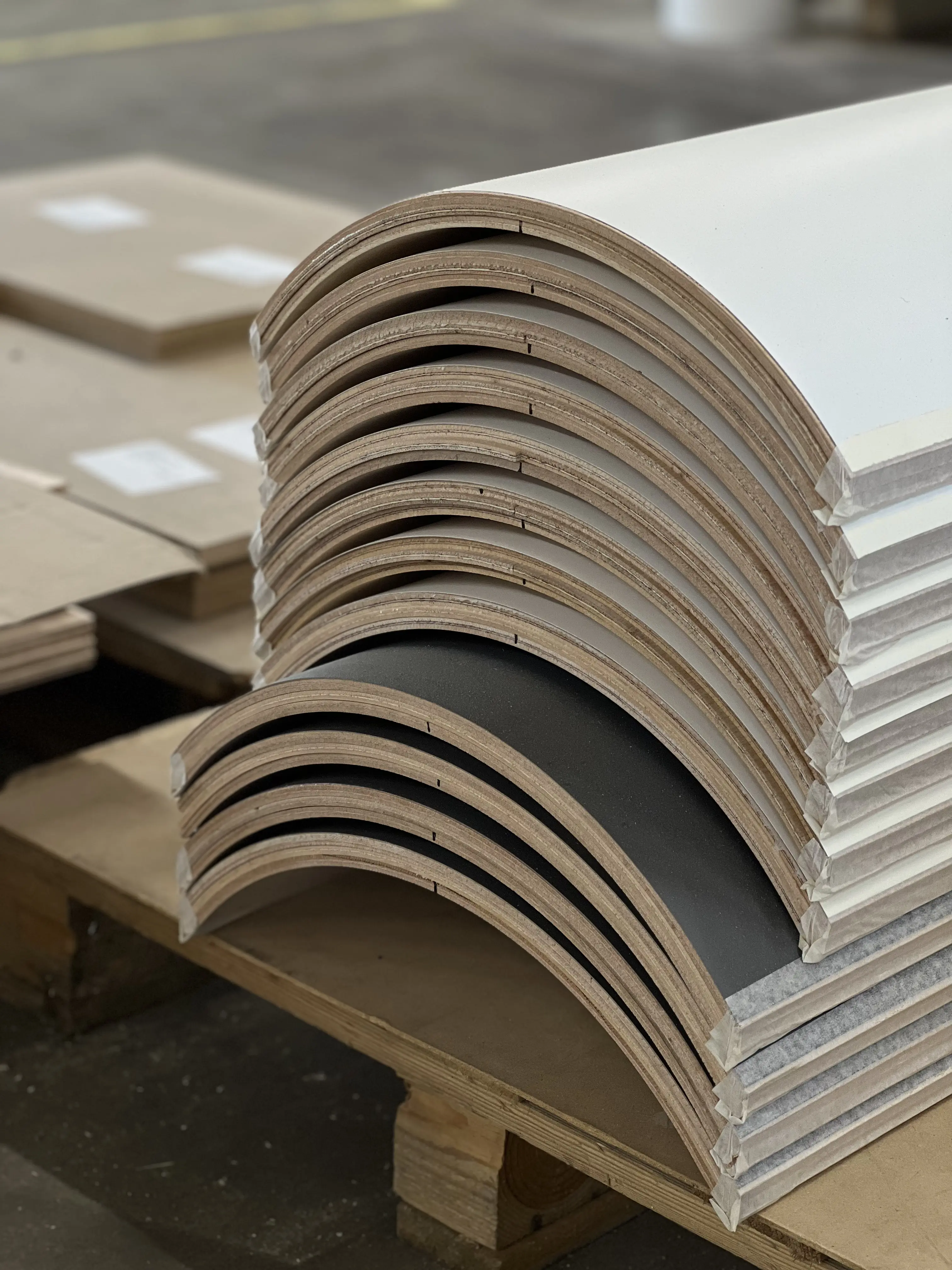 Curved laminated panels stacked in the Spals factory