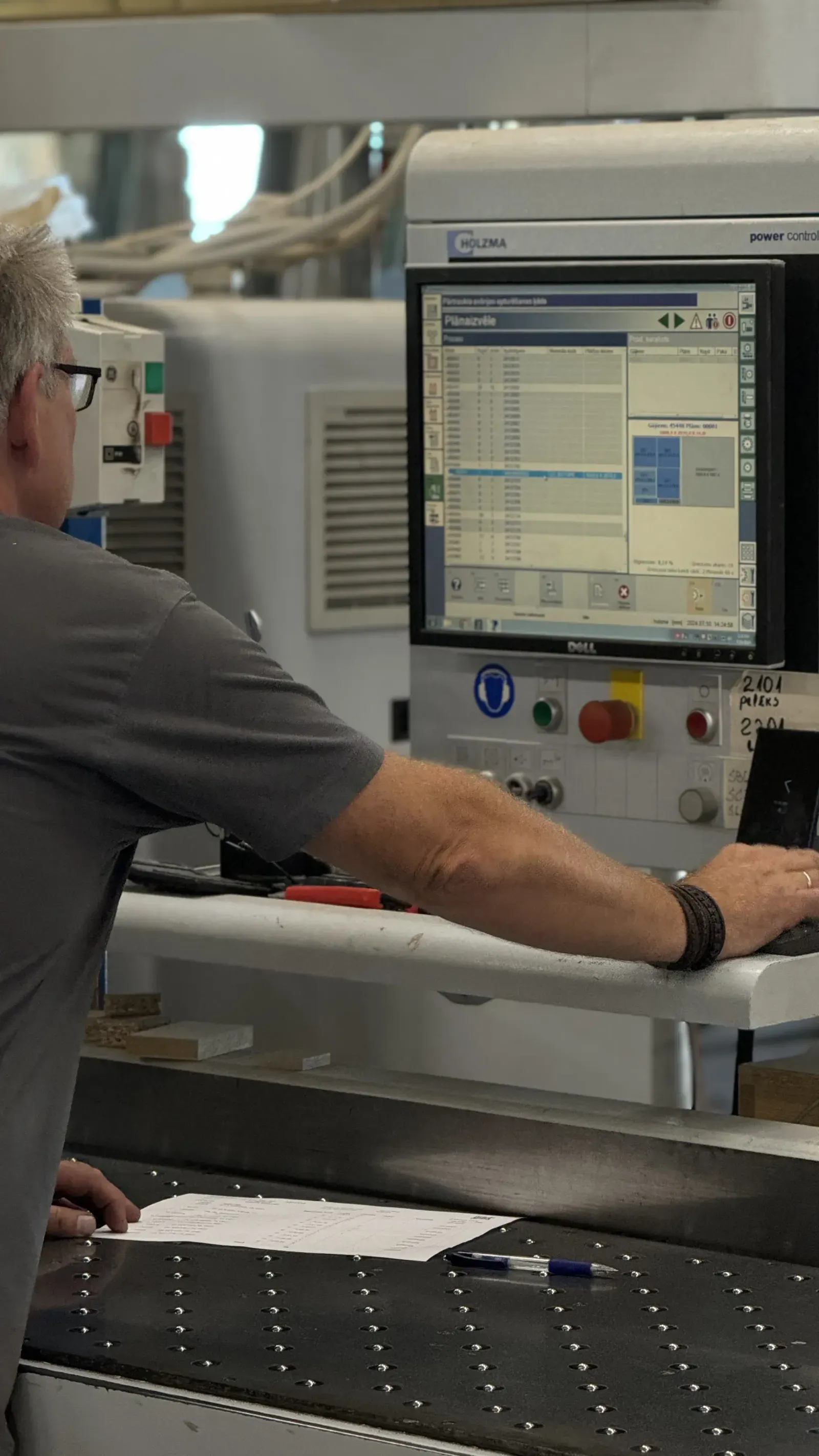 Operator at a CNC machine control panel