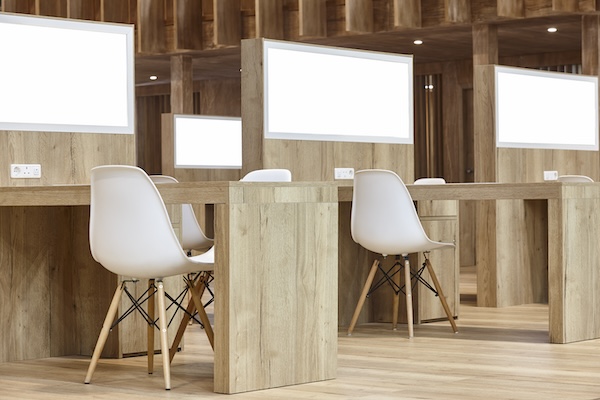 Wooden work desks with white chairs