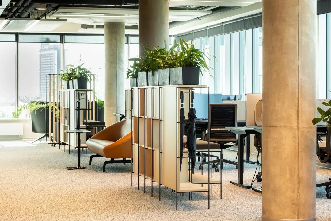 Open-plan office with plant partitions and lounge seating
