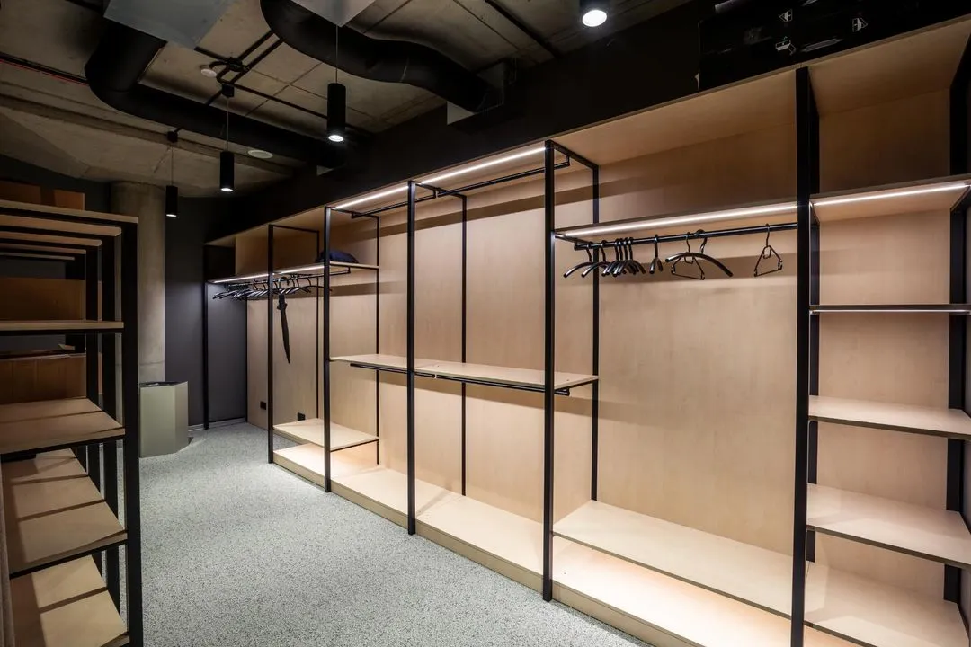 Retail store fit-out with oak shelving and clothing rails