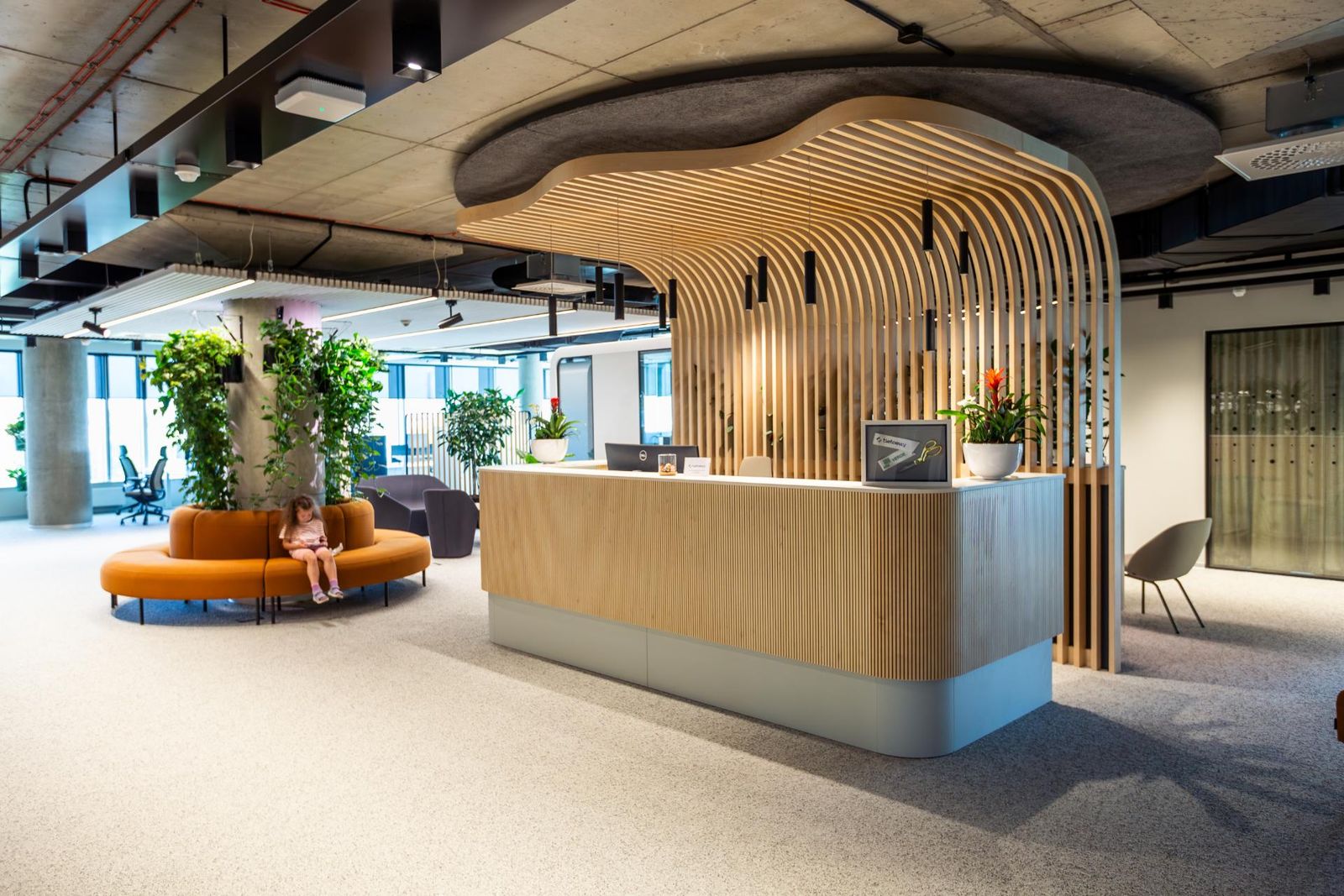 Office reception desk under a wooden slat canopy