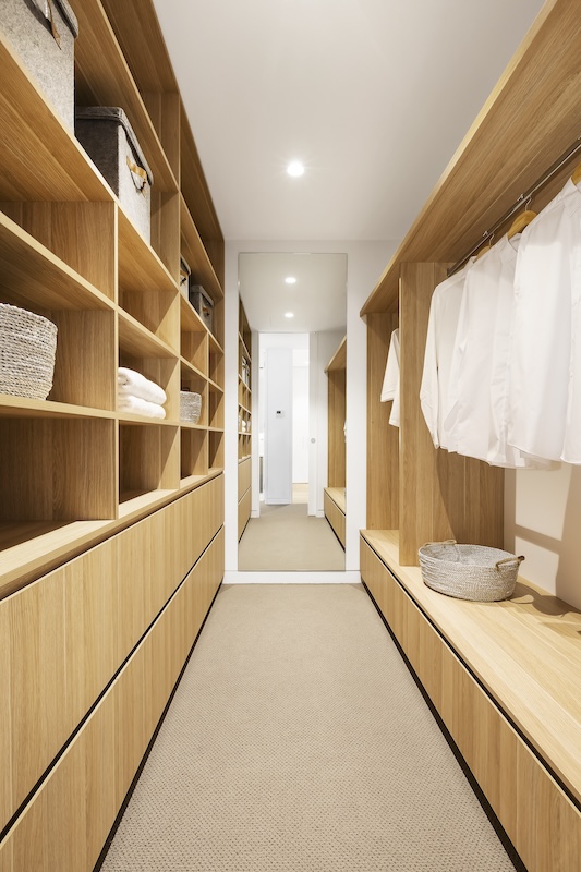Walk-in wardrobe with oak shelving