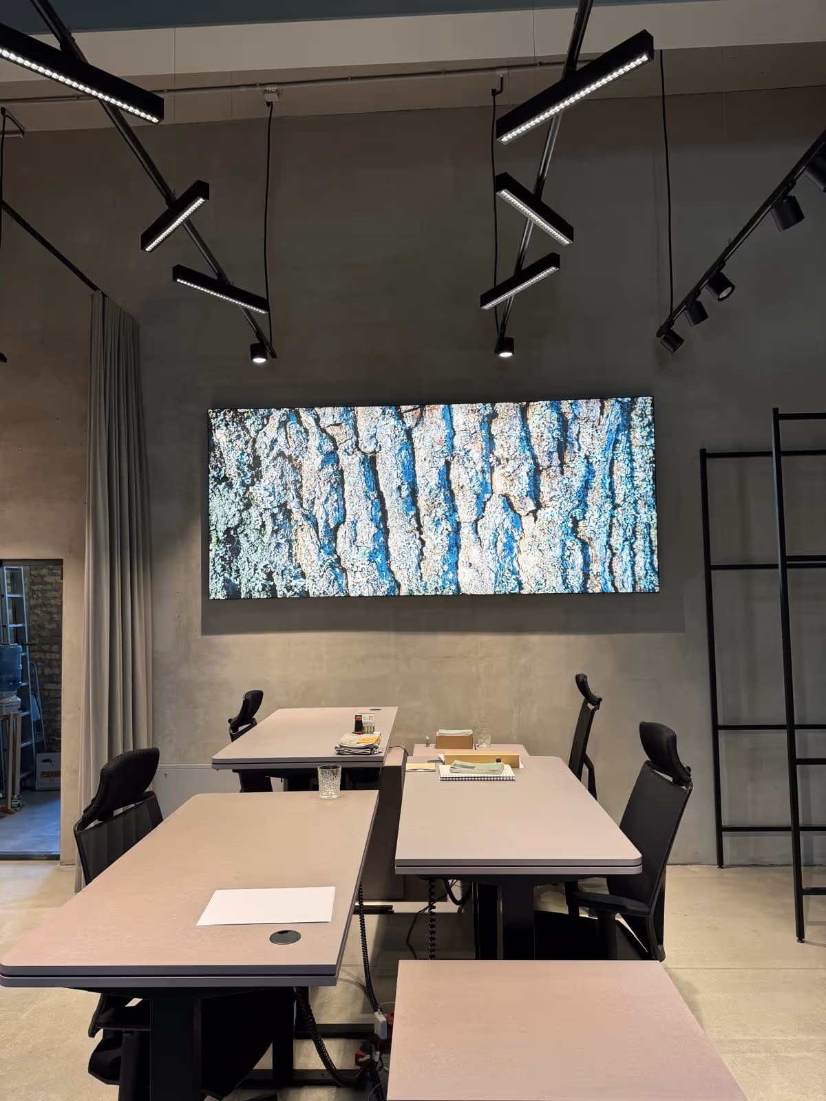 Meeting room with tables and a large wall artwork