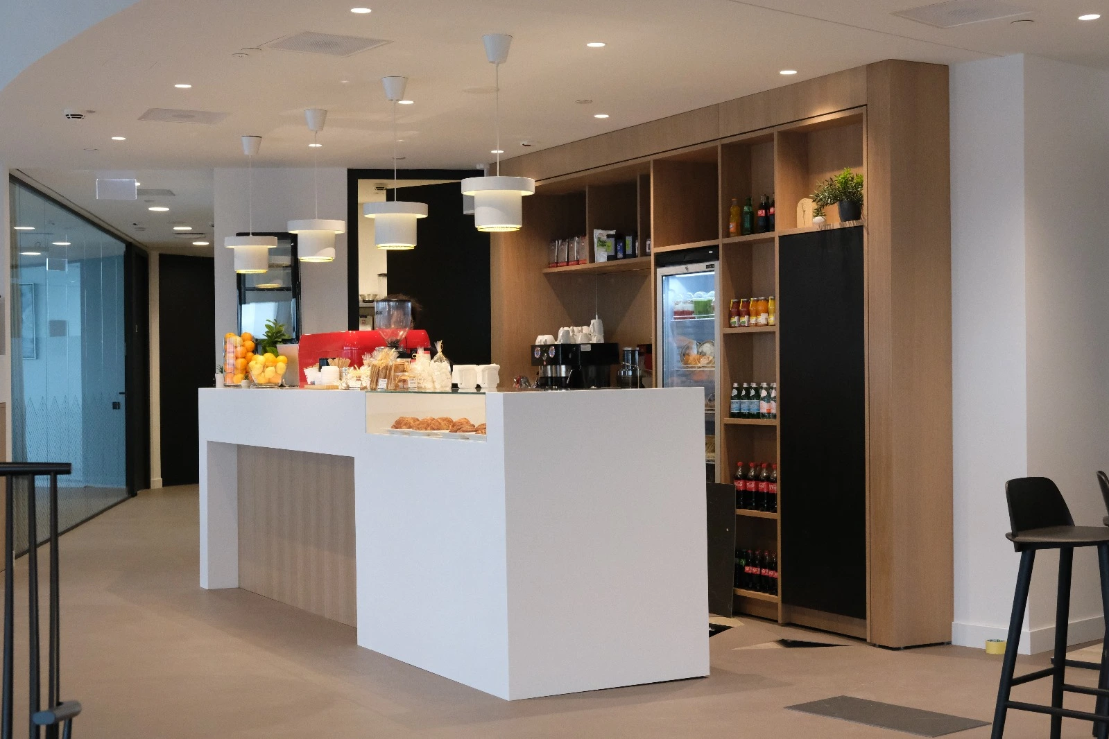 Office café counter with oak shelving and fridges