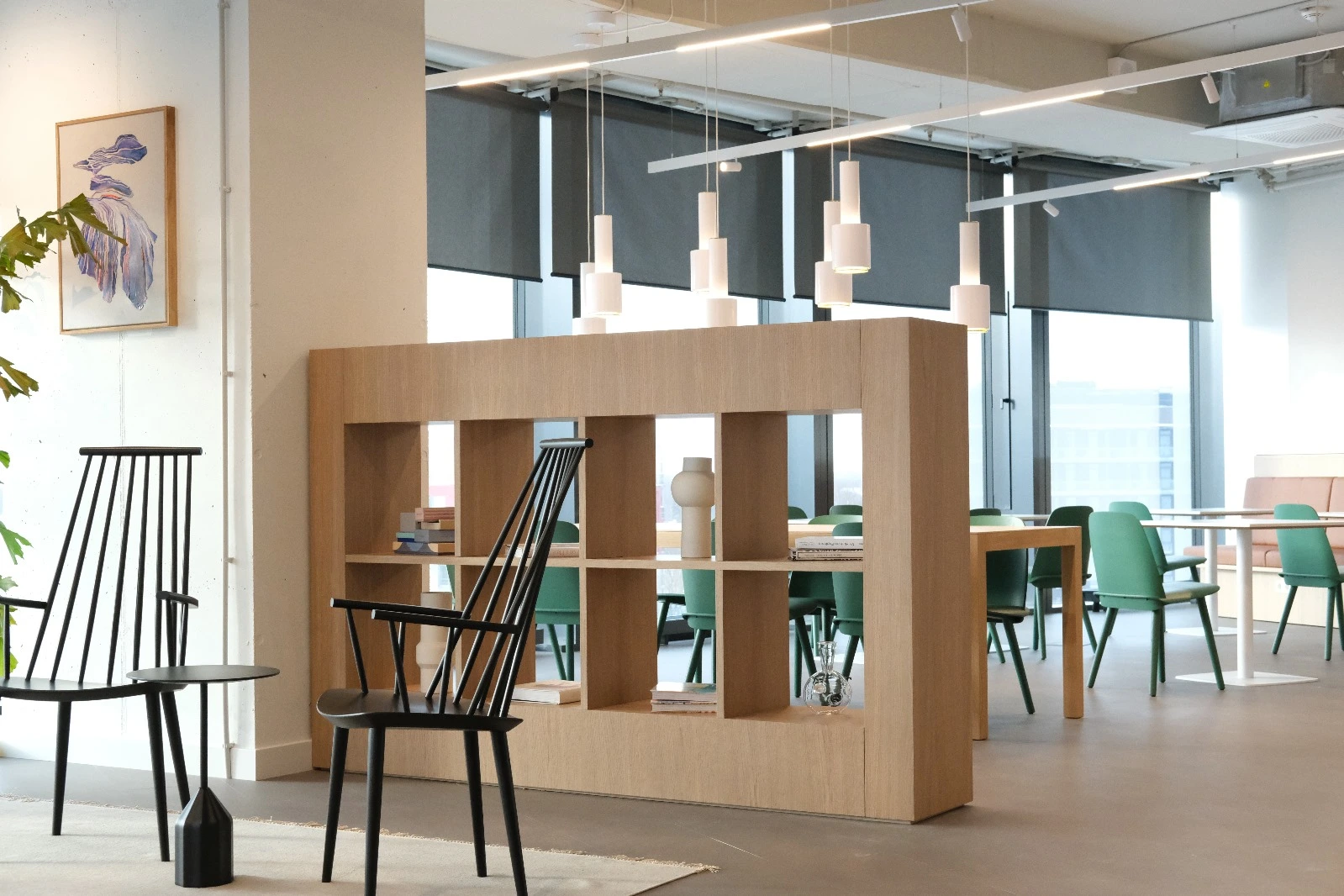 Office interior with an oak shelving unit used as a room divider