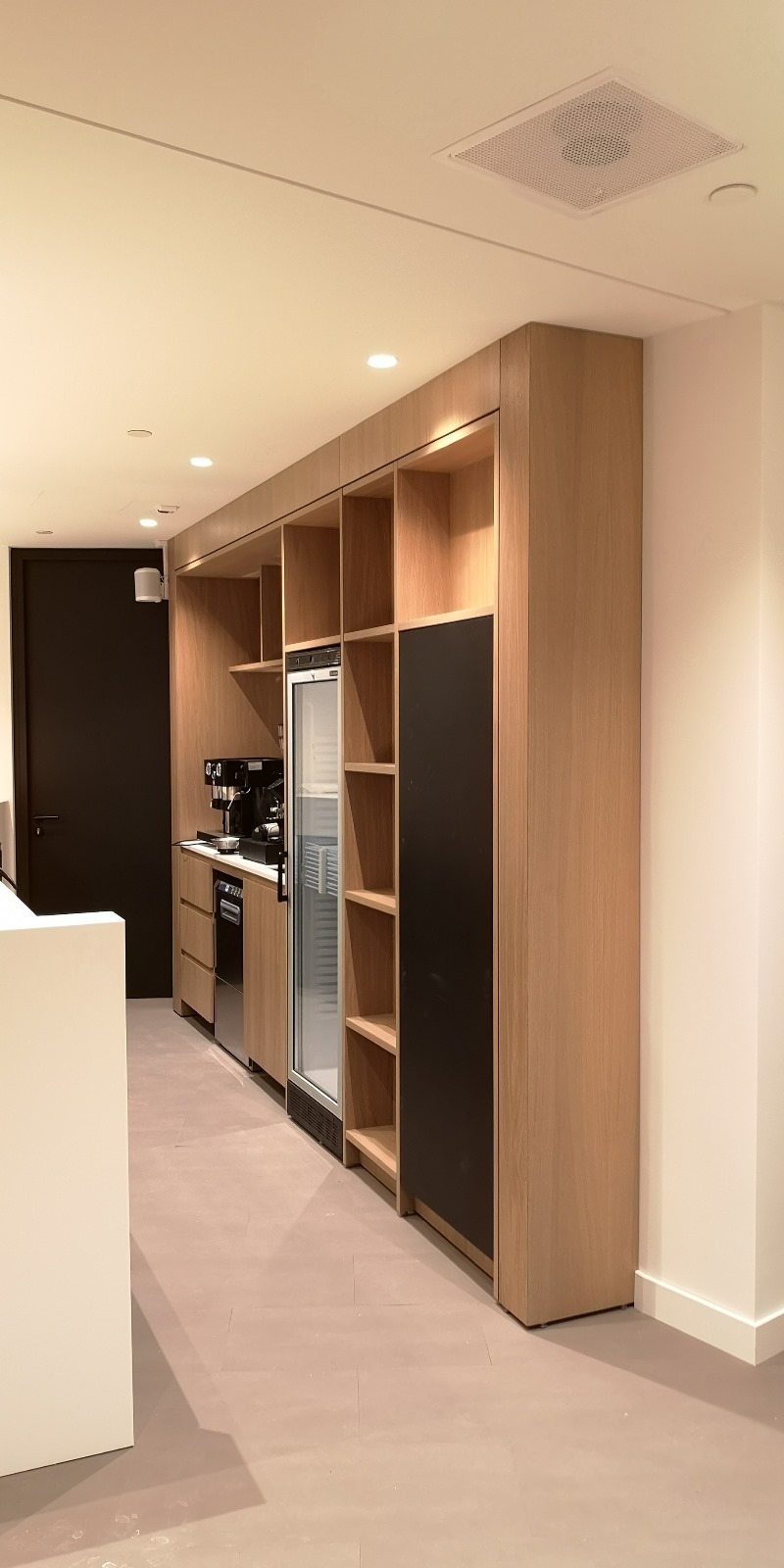 Built-in kitchenette with oak cabinets in an office