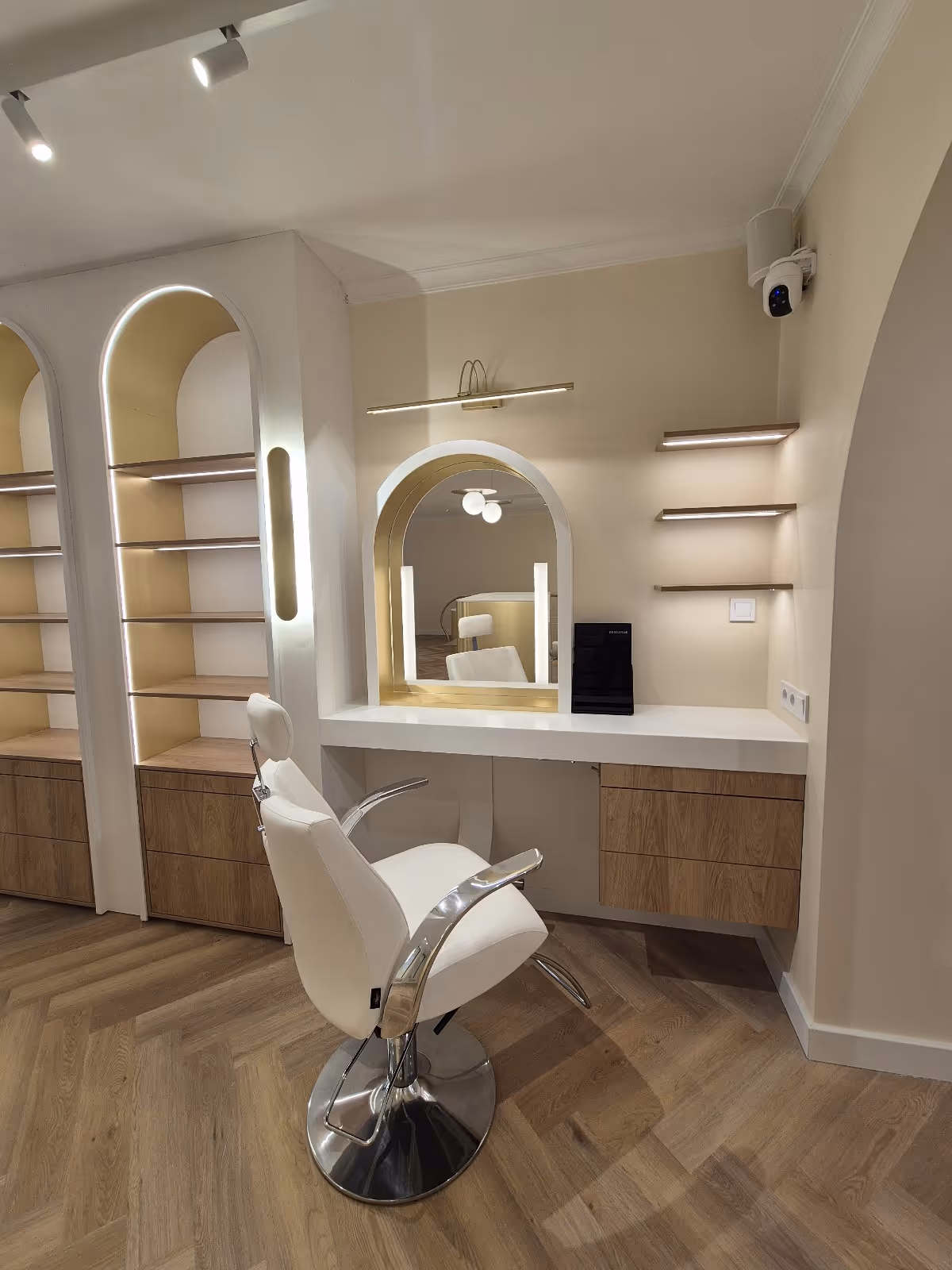 Beauty salon workstation with arched mirror and built-in shelves