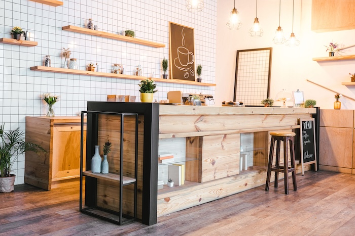 Café counter with wooden shelves and bar stools